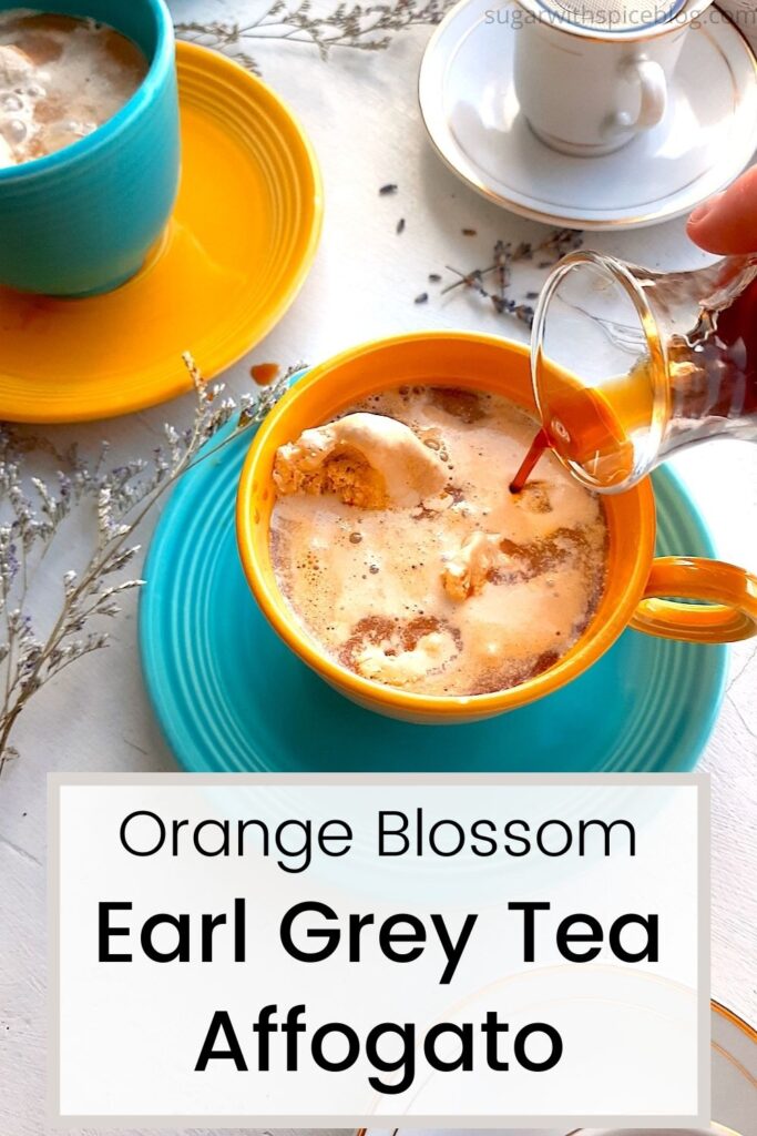 Earl grey tea affogato preparation on a white background. A woman's hand pours espresso from a glass carafe into a yellow tea cup with blue saucer over earl grey ice cream. A white espresso cup with black espresso, a second affogato in a blue cup and yellow saucer, and sprigs of lavender and babies breath in the background. Text overlay says orange blossom earl grey tea affogato. Pinterest image. Sugar with Spice Blog.